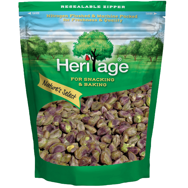 Heritage Pistachios in a clear bowl, showcasing vibrant green and brown roasted pistachio nuts, ideal for confectionery snacks.