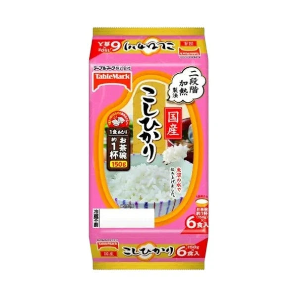Cooked Japanese Koshihikari rice by TABLEMARK, prepared with Uonuma water, displayed in a bowl on a wooden table.