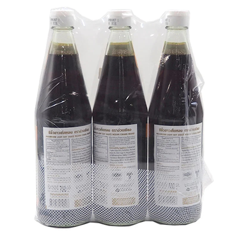 Three bottles of Nguan Chiang Mushroom Sauce, 700g each, in clear glass bottles with labels, suitable for dry grocery shopping.