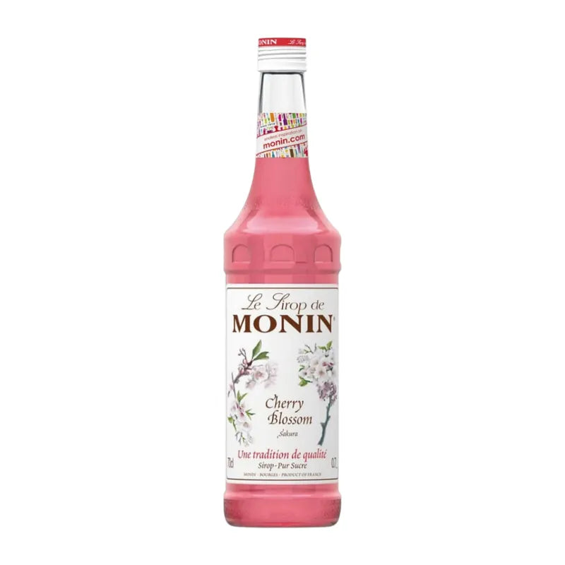Bottle of MONIN Cherry Blossom Syrup 700ml for dry grocery use, featuring cherry blossom flavor in a clear plastic bottle.