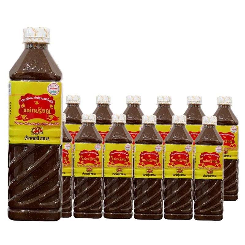 Maerien fermented fish sauce 700ml bottle, typical for Asian cuisine, displayed in a group of 12 bottles in a dry grocery setting.