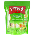 A glass cup of Fitne Green Tea Herbal Infusion drink with fresh green tea leaves and herbs visible inside the transparent cup.