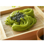 Kanesu Chasoba Uji Midori green tea soba noodles, dry Japanese grocery product, with vibrant green color and thin noodle strands