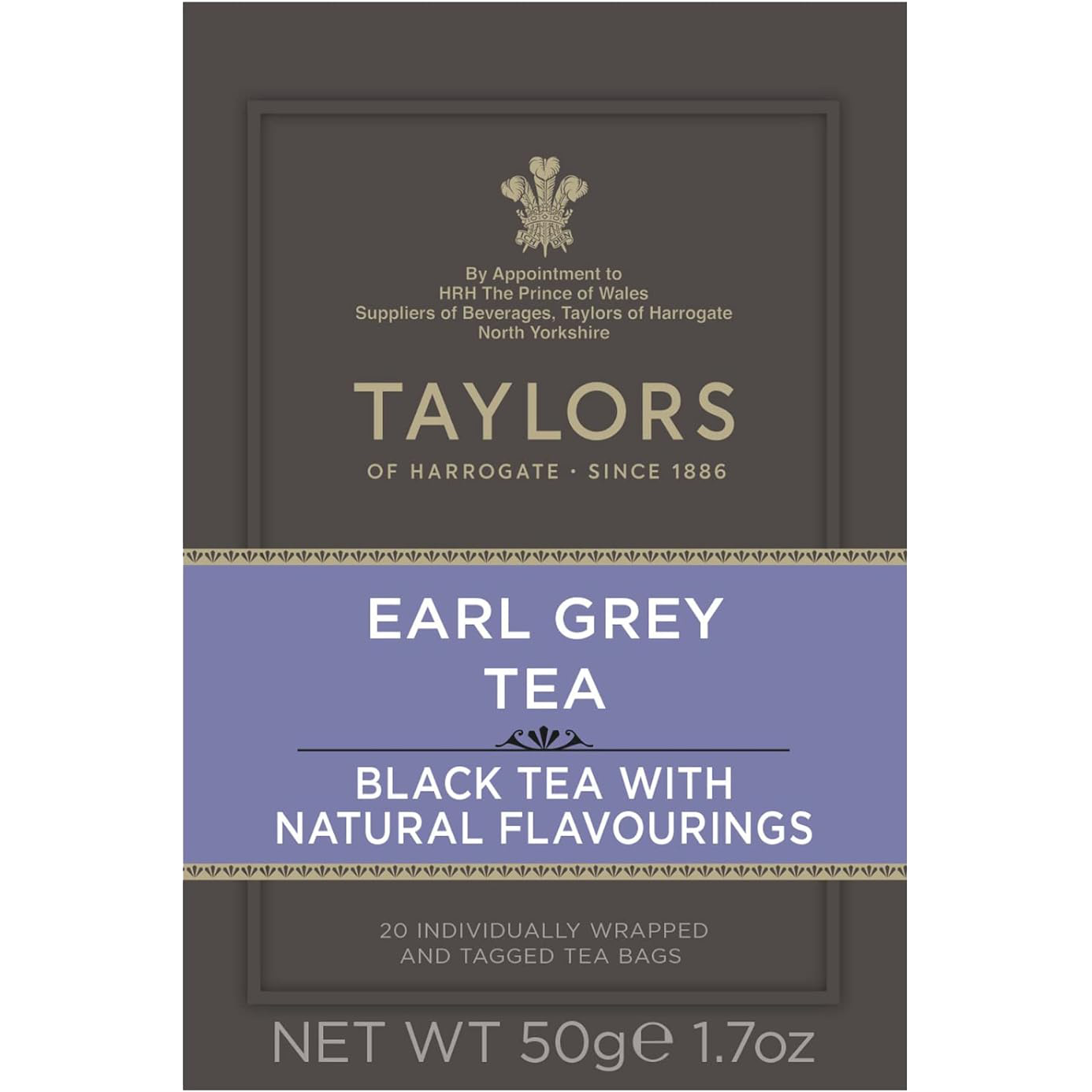 A cup of brewed Taylors Earl Grey Tea with a teapot and lemon wedge on a wooden table, showcasing the tea's rich color.