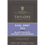A cup of brewed Taylors Earl Grey Tea with a teapot and lemon wedge on a wooden table, showcasing the tea's rich color.