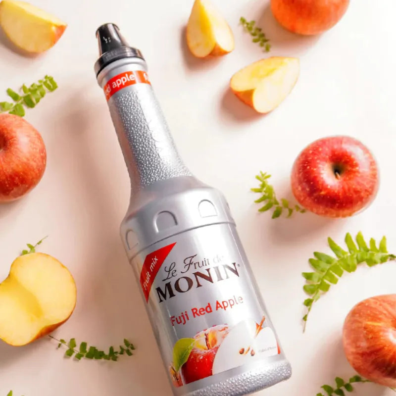 Bottle of MONIN Fuji Red Apple Fruit Mix 1000ml, a dry grocery syrup with vibrant red apple flavor