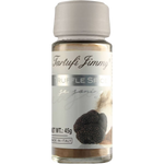 Jar of Tartufi Jimmy Truffle Spice with black truffle flakes, packaging label visible, used for gourmet cooking and seasoning.