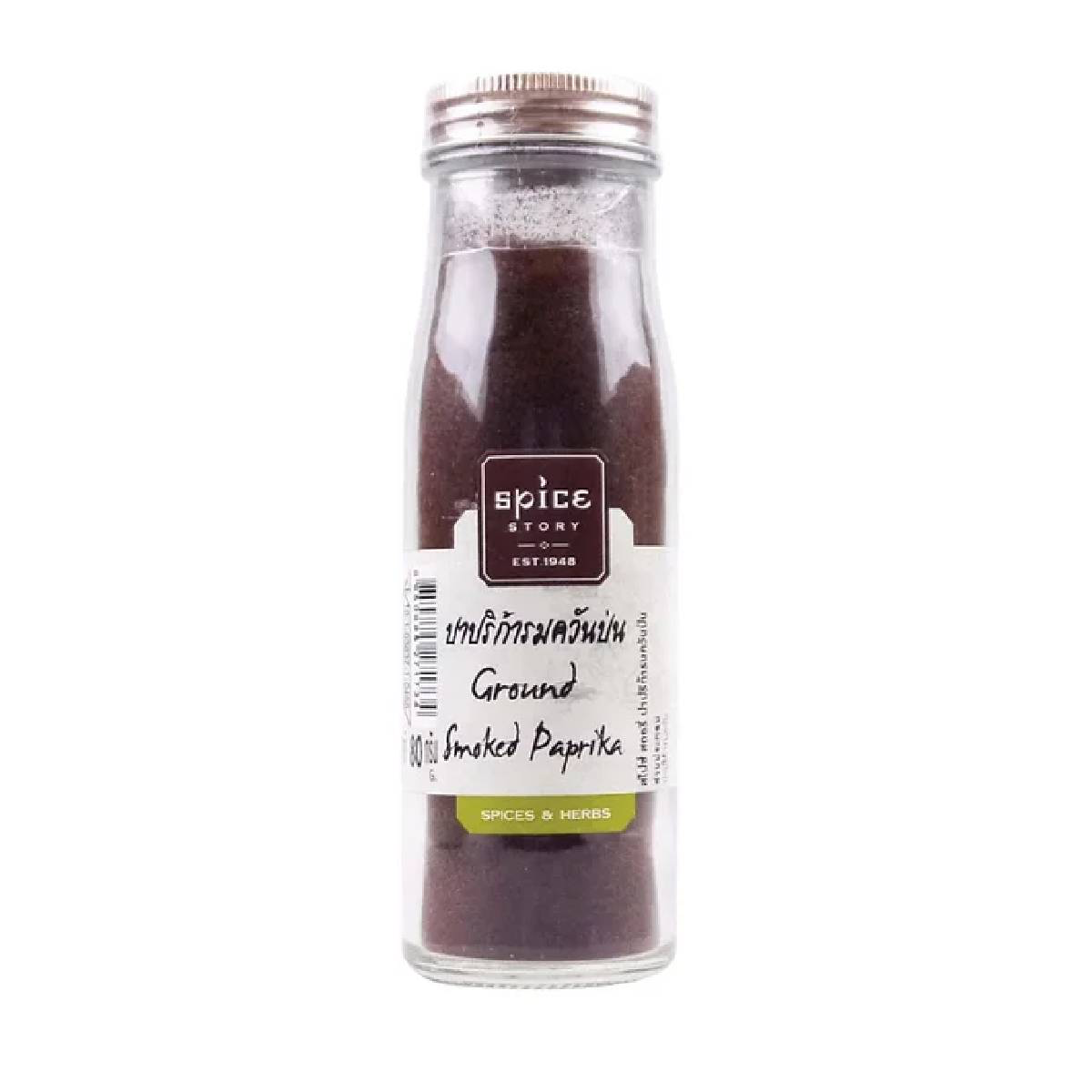Ground smoked paprika from Spice Story, vibrant red spice in a glass jar, used to add smoky flavor to dishes.