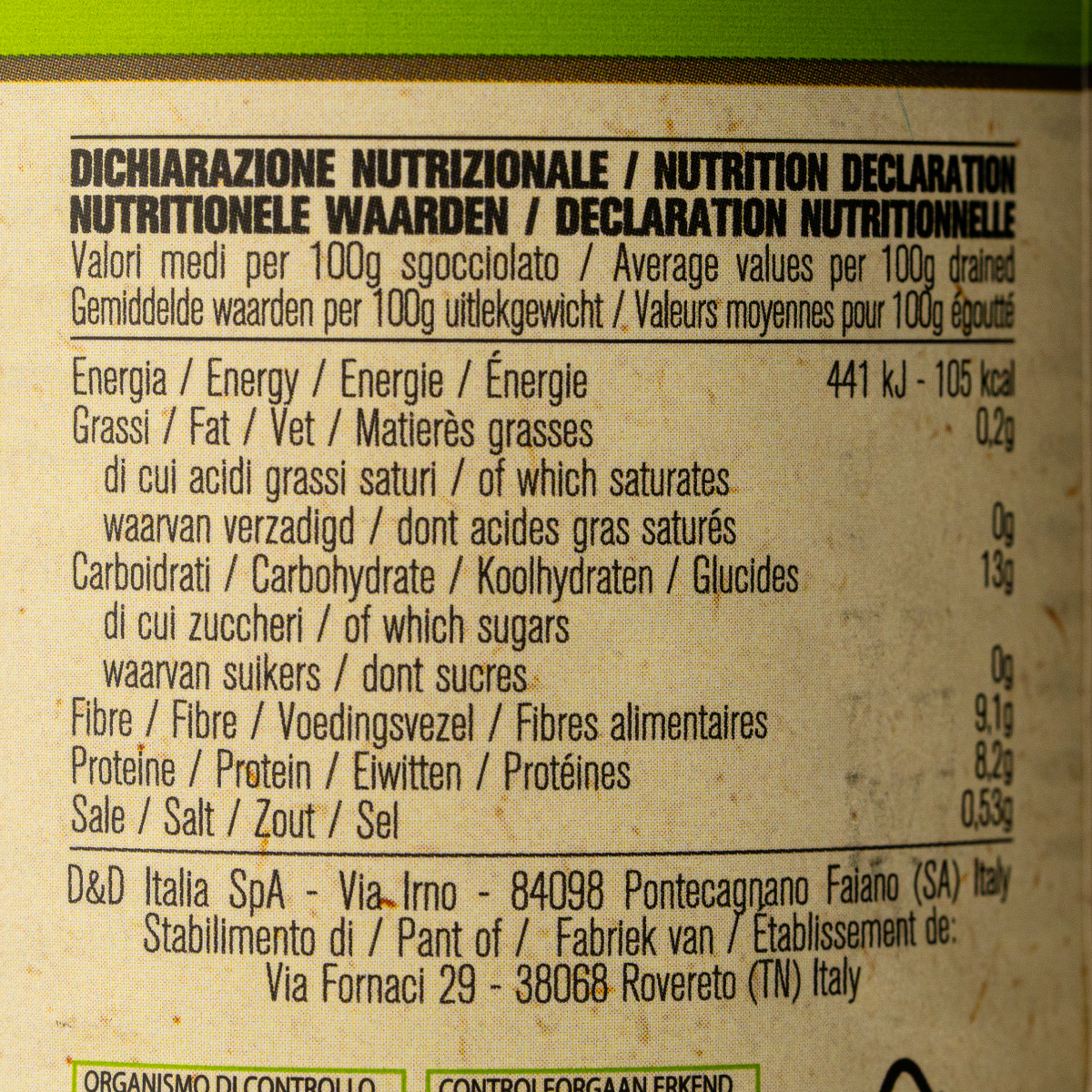 Canned D'Amico Organic Black Beans in a grocery store, showing the label and product details on the can.