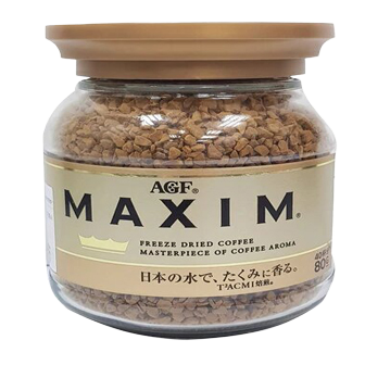 A cup of Maxim Gold Instant Coffee drink with a spoon and coffee beans on a white background.