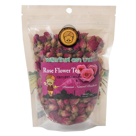 A glass of Baboo Rose Flower Tea with fresh rose petals and blooming rose flowers, served in a clear glass.