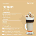 Monin Popcorn Syrup 700ml bottle, rich caramel flavor, perfect for adding popcorn or dessert toppings in dry grocery products.