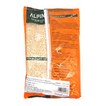 Alpine Urad Dal 500g, dry Indian lentils in a clear bag, showcasing small black and white split urad dal grains.