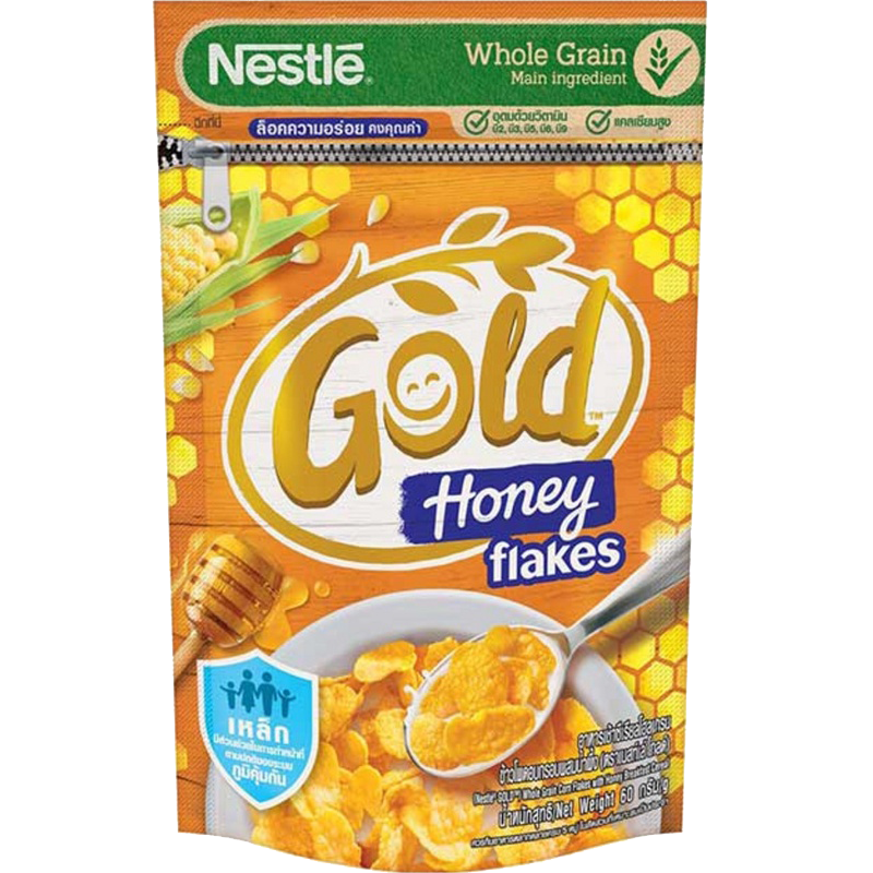 Nestle Gold Honey Flakes cereal in a bowl with milk, showing golden flakes and honey flavor details.