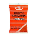 S & B Marco Polo Chili Pepper Ichimi Togarashi dry spice in four 300g bags, featuring bright red chili powder for flavorful dishes.
