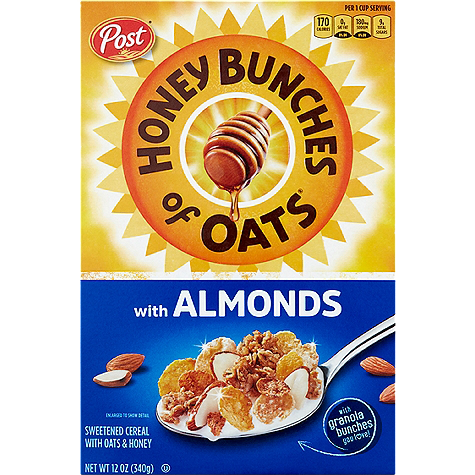 Bowl of Post Honey Bunches of Oats with Almonds cereal in a white bowl on a wooden table, showing crunchy oats and almond pieces.