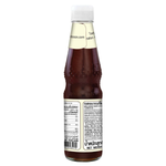 Deksomboon Keto Oyster Sauce bottle in a grocery setting, showcasing the product label and packaging.