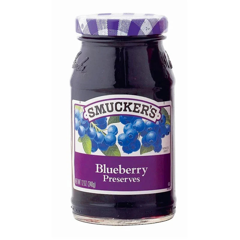 Jar of Smucker's blueberry jam with blue and purple fruit on the label, 340g bottle, ideal for spreading or baking.