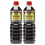 Two 1-liter bottles of Kikkoman soy sauce in clear plastic containers, showing the Kikkoman branding and dark soy sauce inside.