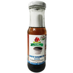 Guyvy Healthy Shoyu Sesame Oil Dressing bottle, close-up of label and transparent container showing the dark sesame oil dressing.