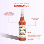 Bottle of MONIN Cinnamon Syrup in a 700ml clear plastic bottle with a black cap, suitable for flavoring beverages and desserts.