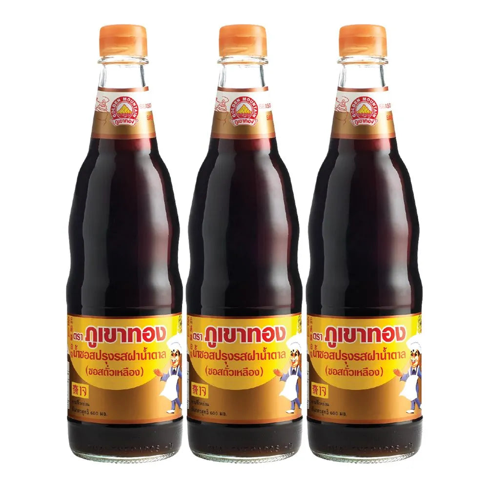 Three bottles of Golden Mountain Sauce Brown, 600ml each, in a dry grocery setting, showcasing the product packaging and labels.