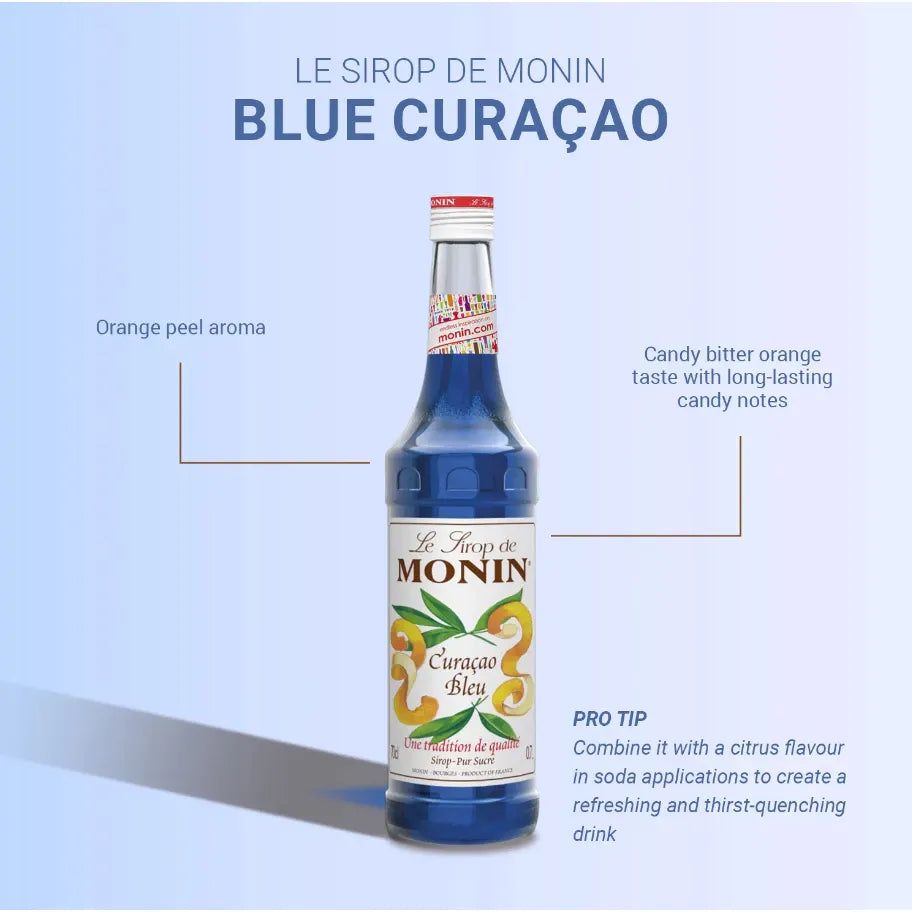 Bottle of Monin Blue Curacao Syrup in 700ml size, for cocktails and beverages, displayed on a shelf.