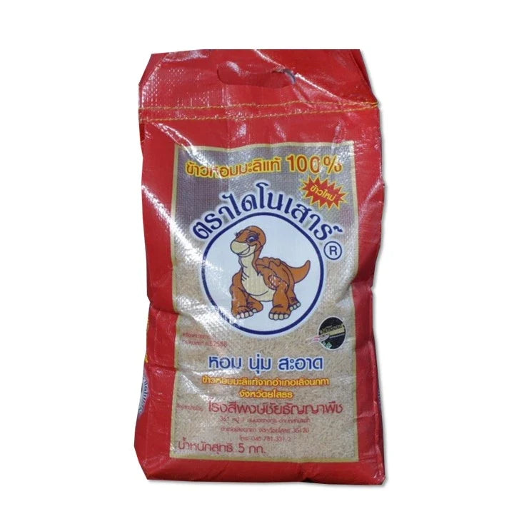 Dinosaur Rice Brown 5kg dry grocery package with a colorful label, showcasing uncooked brown rice grains.
