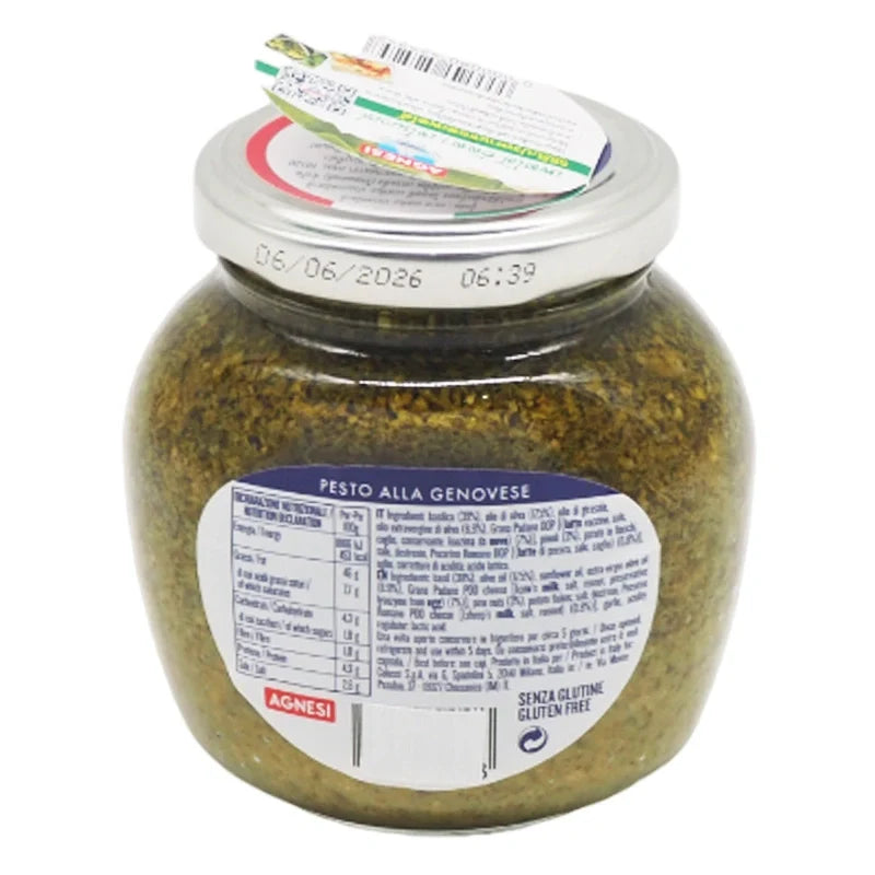 Close-up of Agnesi Pesto Sauce 185g jar with fresh basil, garlic, and pine nuts visible, showcasing the Italian dry grocery product.