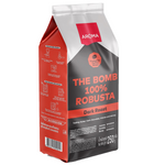 Aroma The Bomb Robusta roasted coffee drink in a glass, showcasing rich dark coffee with a frothy top.