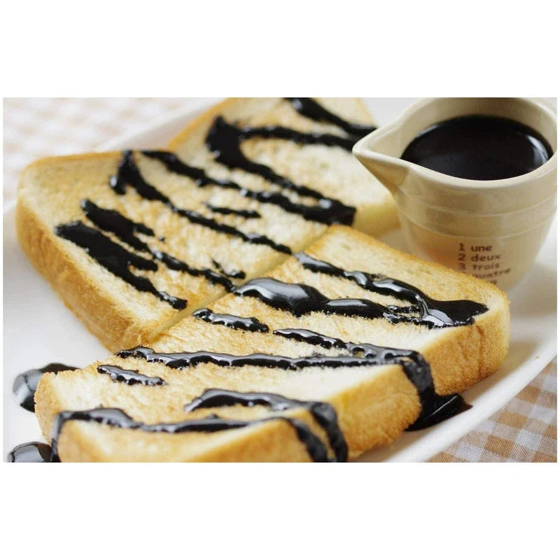Kuki Sangyo Jun Nerigoma Kuro sesame paste with roasted Japanese sesame seeds, in a jar, for Asian cuisine and cooking.