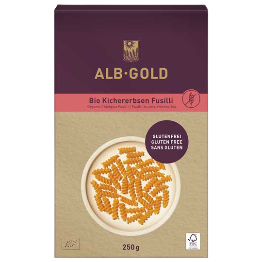 Alb Gold chickpea fusilli pasta in a clear bowl, showcasing the light beige, spiral-shaped gluten-free pasta on a white background.