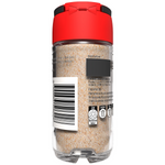 Jar of McCormick garlic powder for cooking, with a clear label and a white spice container on a kitchen countertop.