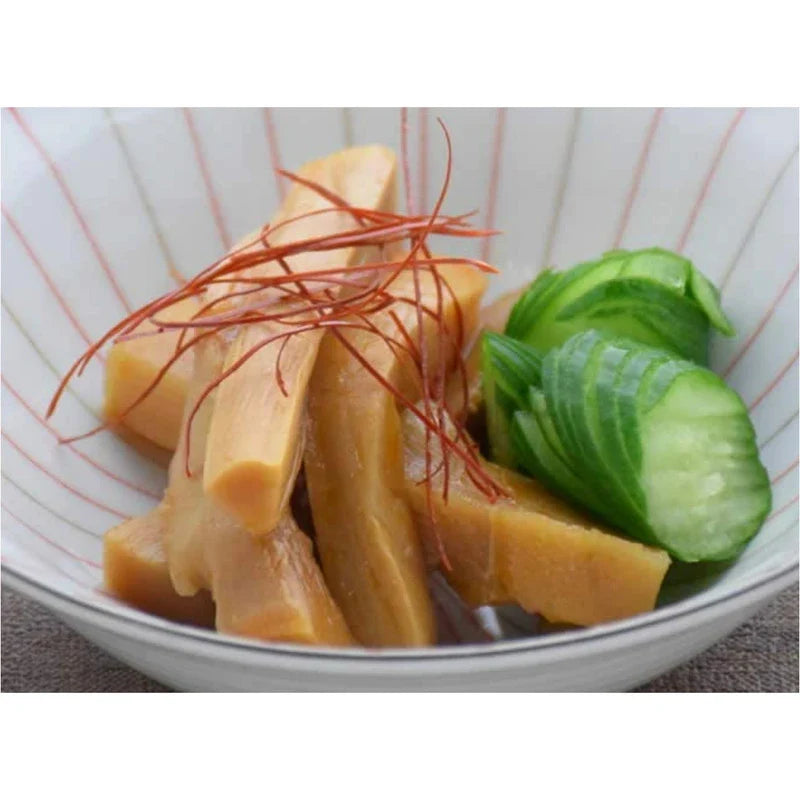 Dried Keihin seasoned ajitsuke menma bamboo shoot in a clear container, showcasing the thick, flavorful bamboo shoots for Asian cooking.