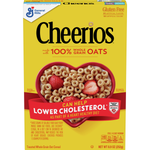 Bowl of General Mills Cheerios oat cereal in a white bowl on a wooden table, ready to eat.