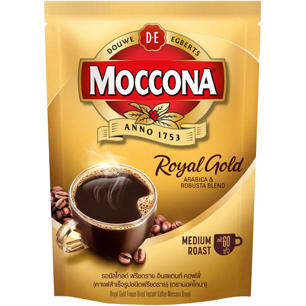Moccona Royal Gold instant coffee drink served in a glass cup with a frothy top and caramel color liquid.