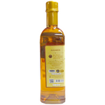 Organic Thai honey from Organik, wildflower variety, with a golden, viscous appearance in a clear jar.
