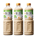 Yamamori Caesar Salad Dressing 1L bottles, three-pack, in clear bottles with yellow labels, displayed on a kitchen counter.