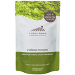 Choui Fong Green Tea Powder drink in a glass, showcasing vibrant green tea beverage with a frothy top and fresh green tea leaves.