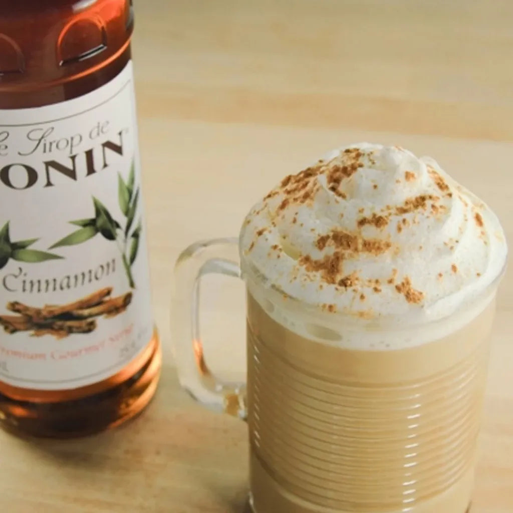 Bottle of MONIN Cinnamon Syrup in 700ml bottle, featuring the label and cinnamon flavor details on the dry grocery product.