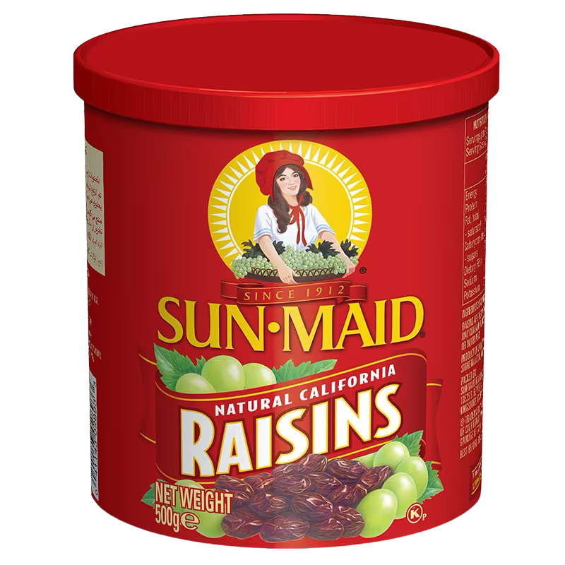 Sunmaid Raisins in a clear glass bowl, showcasing plump, sweet dried grapes perfect for snacks or baking.