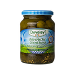 Develey Bavarian Cornichons in a jar, small pickled cucumbers with a crunchy texture and tangy flavor, on a grocery shelf.