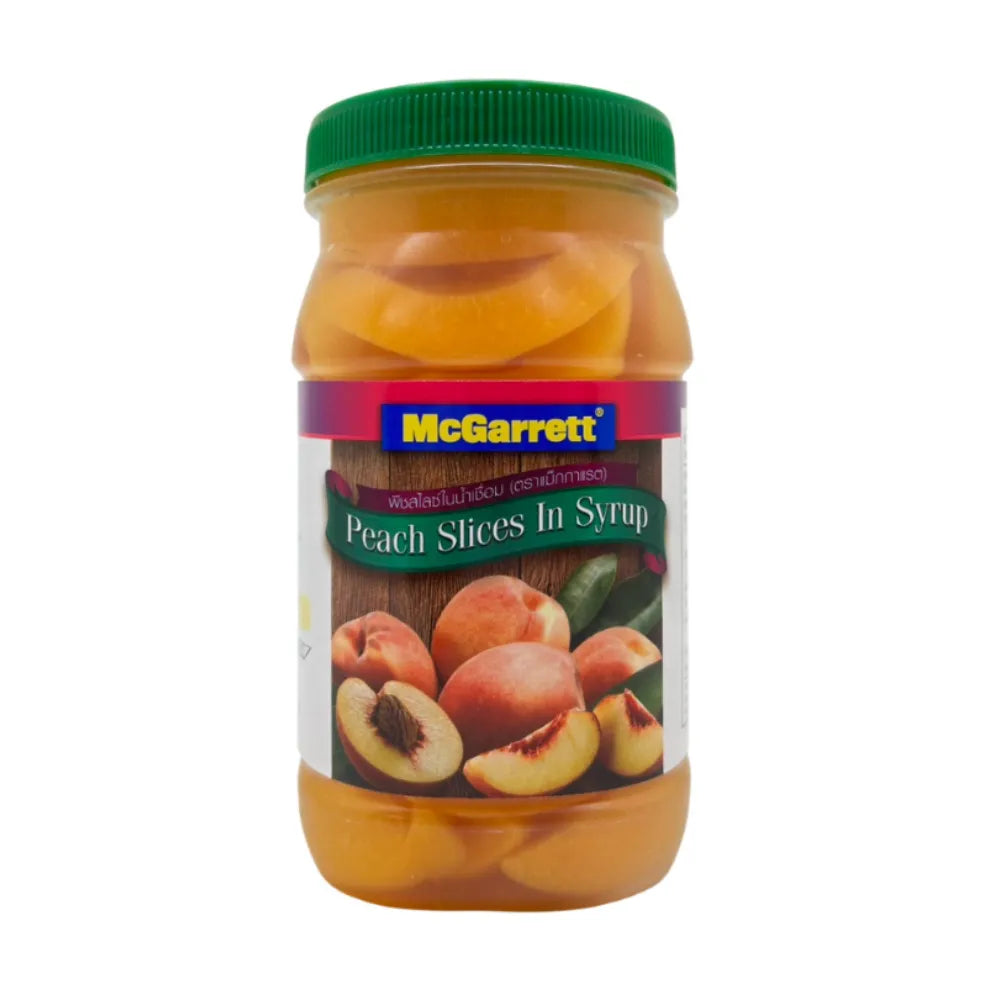 Canned Mcgarrett Peach Slices in Syrup 695g jar, showing peach slices submerged in syrup, in a clear glass jar with label.