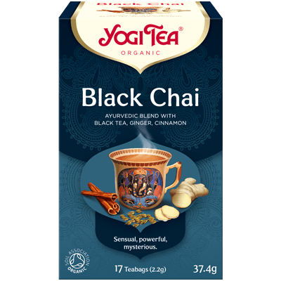 A cup of Yogi Black Chai tea in a mug, showcasing the rich dark color of the brewed chai beverage.