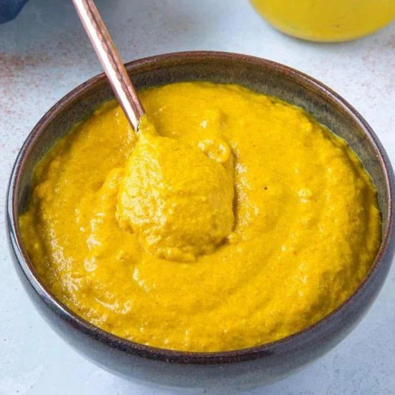 Brook Mustard Powder 50g in a clear jar, dry grocery product with bright yellow mustard powder visible inside.