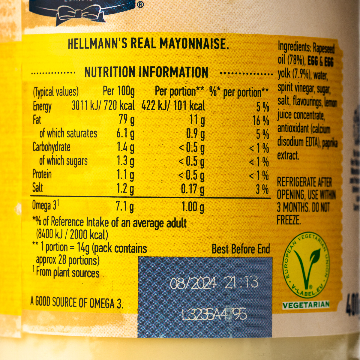 Jar of Hellmann's Real Mayonnaise with a white label and yellow lid, showcasing creamy mayonnaise in a grocery product image.