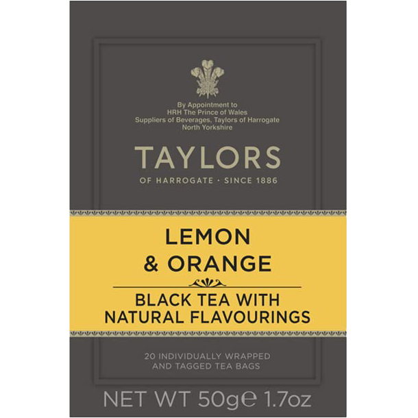 Taylors Lemon Orange Black Tea in a clear glass cup, showing bright yellow lemon and orange slices with dark black tea.