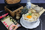 Dried Rabbit Brand Udon Noodles shown in a clear package, ready for cooking, with thick wheat noodles visible inside.