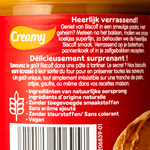 Jar of Lotus Biscoff Creamy Spread with smooth, caramel-colored spread visible inside, on a neutral background.