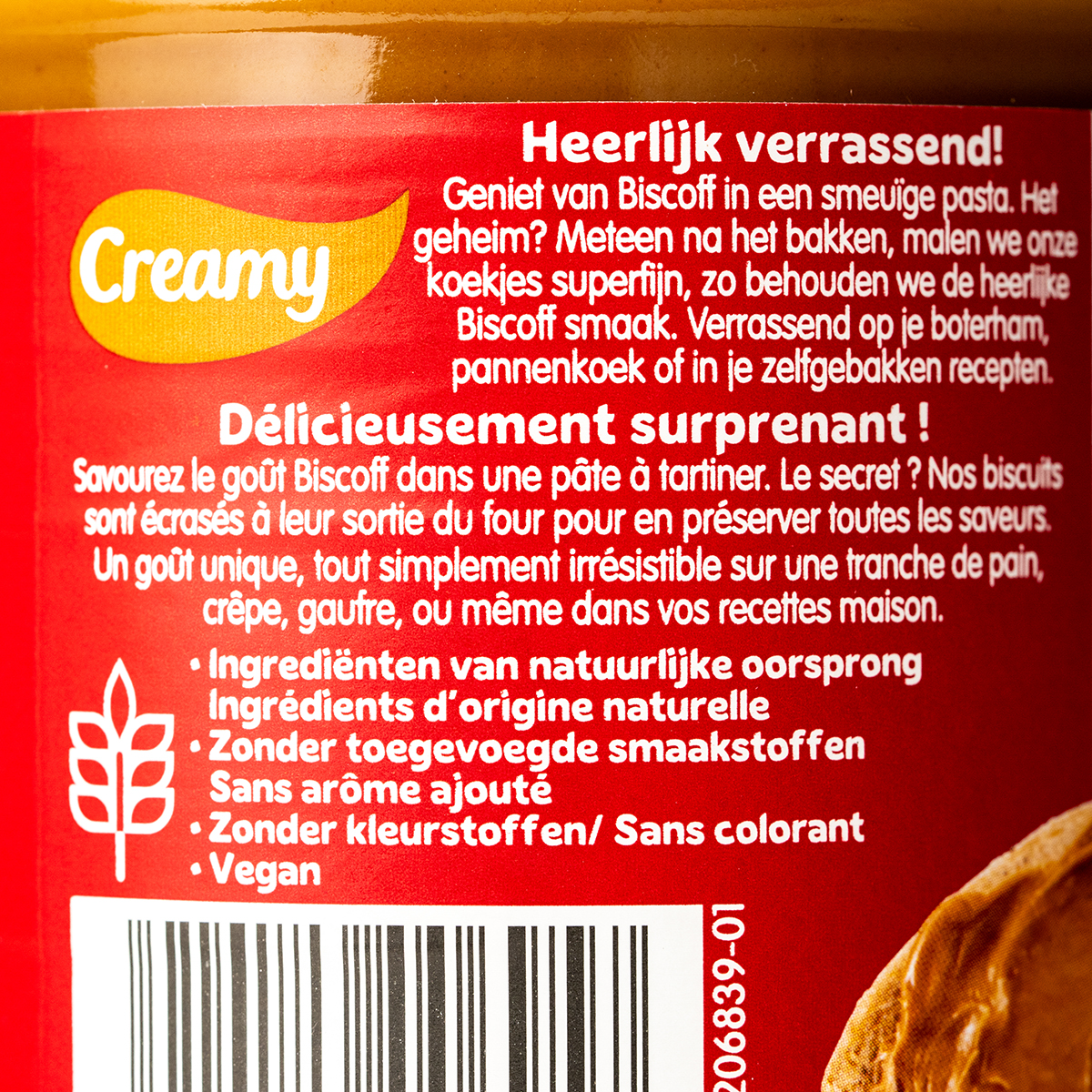 Jar of Lotus Biscoff Creamy Spread with smooth, caramel-colored spread visible inside, on a neutral background.